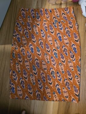 LuLaRoe Orange Printed Pencil Skirt with Navy and Cream Feather Motif